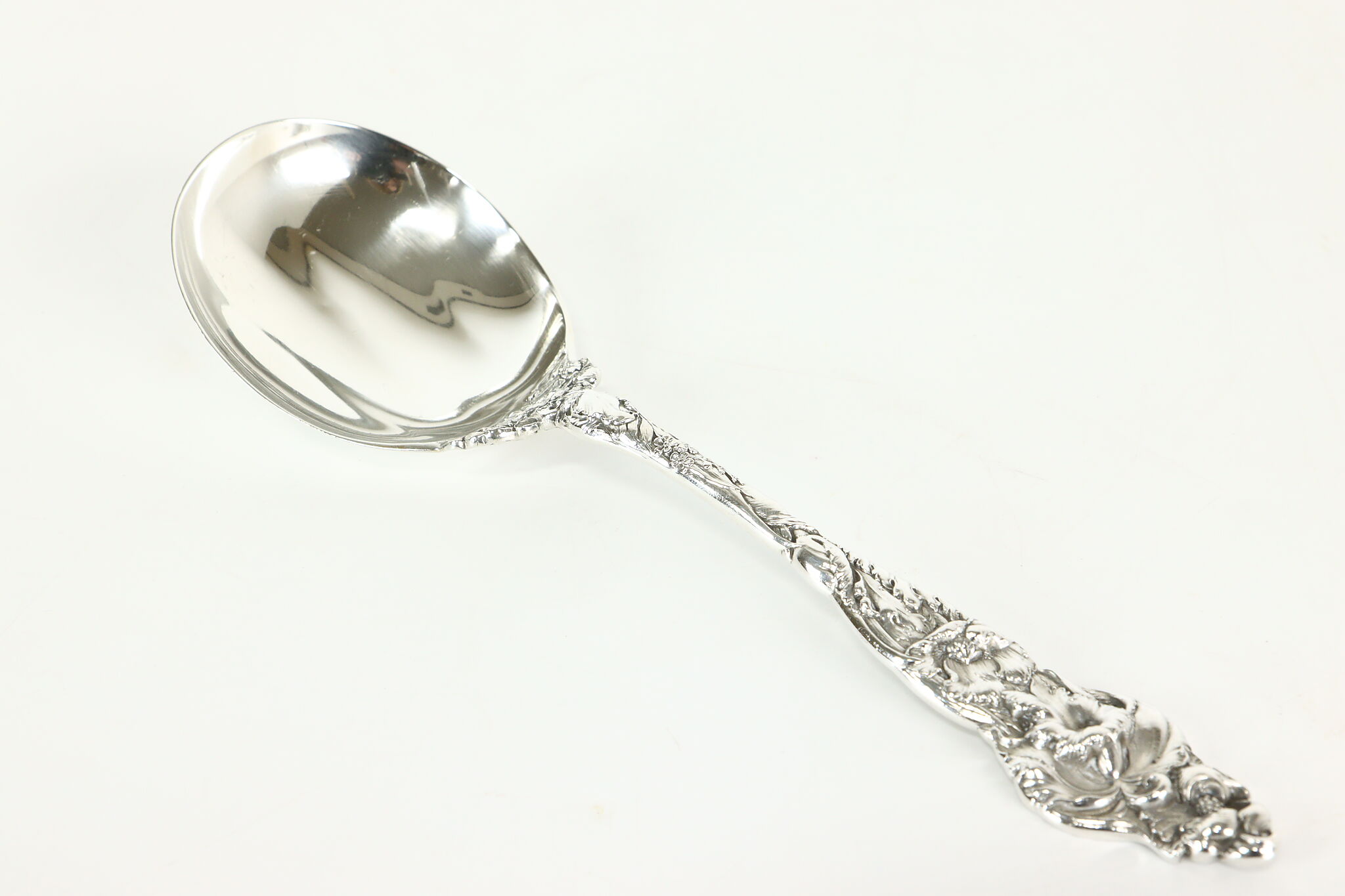 Ornate Silver Teaspoons, Four Spoons with Floral Handles, Arranged in a  Fan-like Manner and Connected