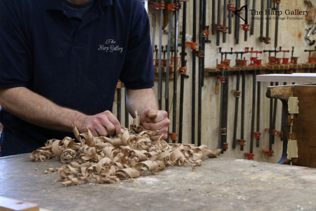 craftsman with wood shavings on table