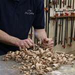 an artisan planing wood