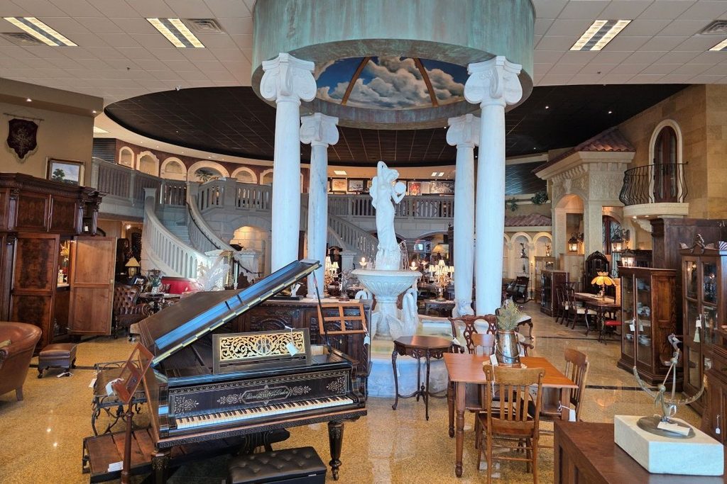 Interior of Harp Gallery showroom with antique furniture, piano, art and architectural details in Kaukauna Wisconsin