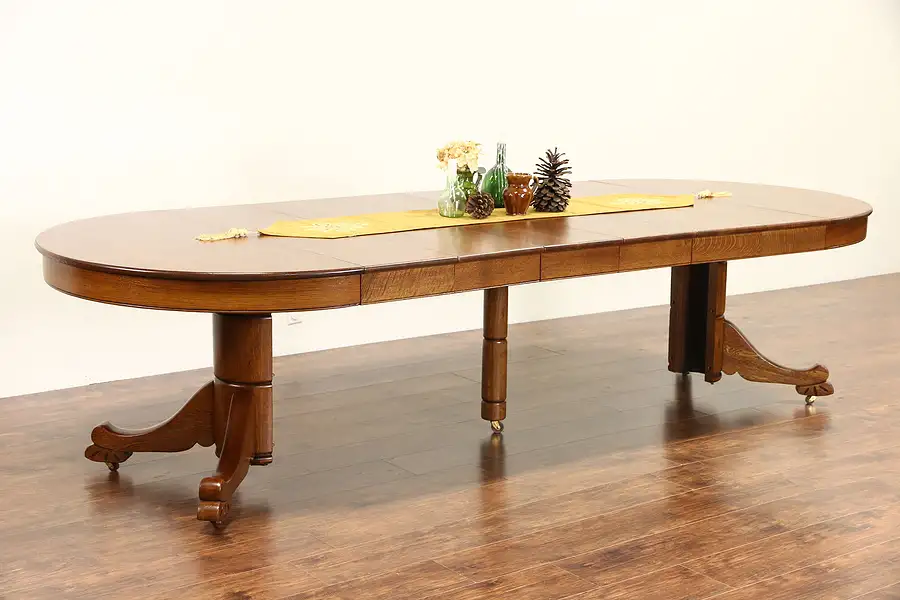 Main image of Oak 4' Round 1910 Antique Carved Pedestal Dining Table, 6 Leaves, Extends 10'