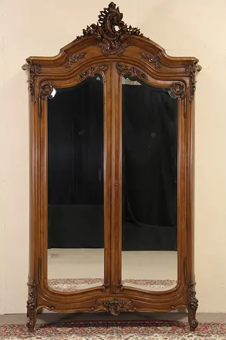 French 1900 Antique Carved Walnut Armoire, Shaped Beveled Mirror Doors