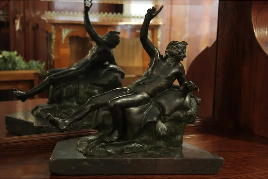 Photo of Bronze Antique Sculpture, Man Resting on Lion Skin