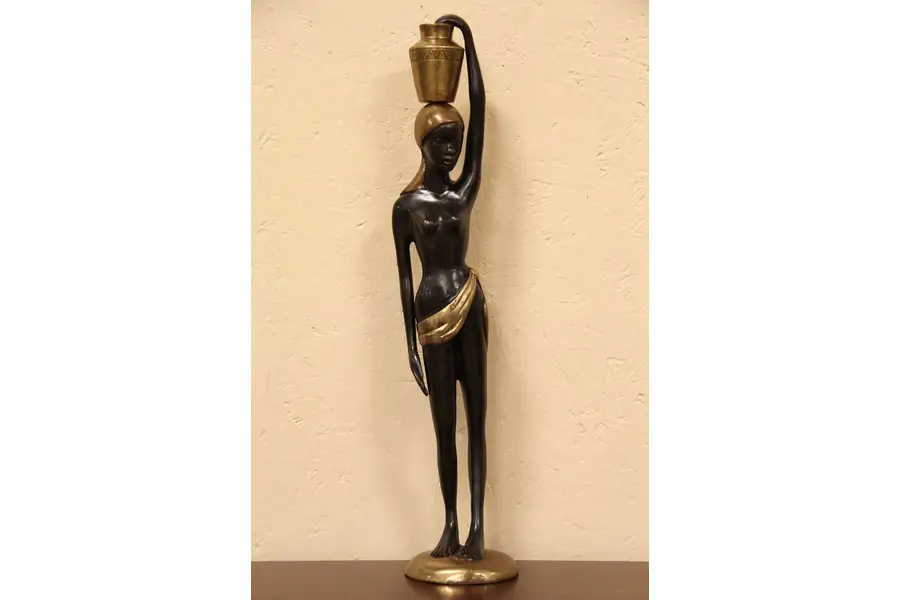 Photo of Bronze Statue of a Woman Carrying a Water Jug