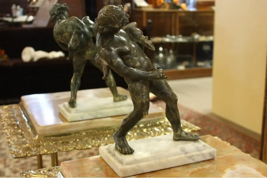 Photo of Bronze Sculpture of a Young Man with a Pig