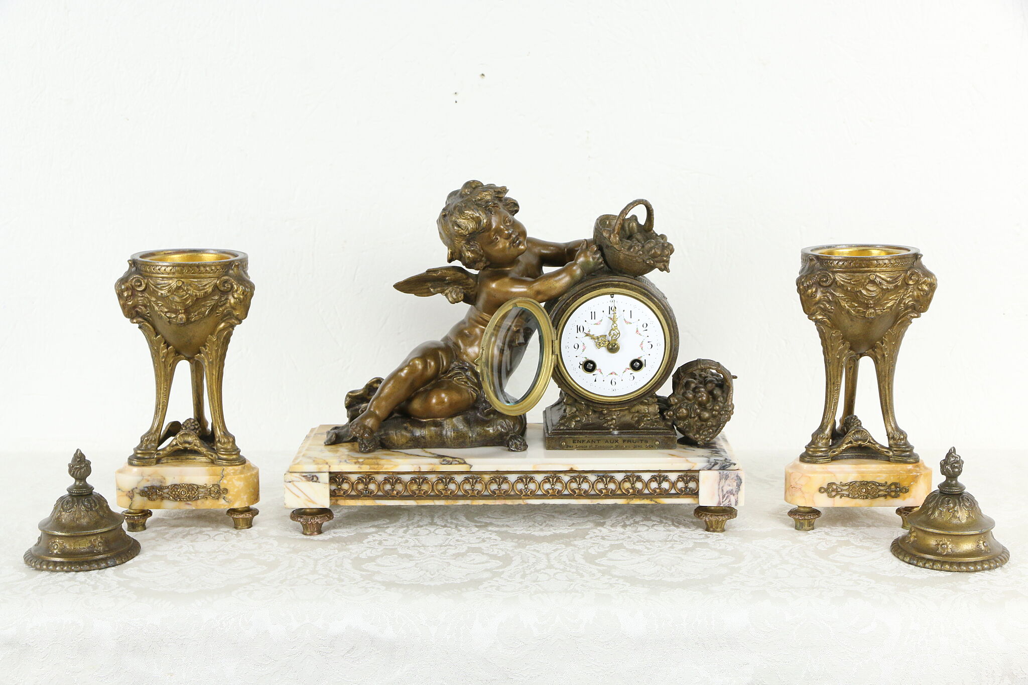 Antique French brass bell-shaped clock set