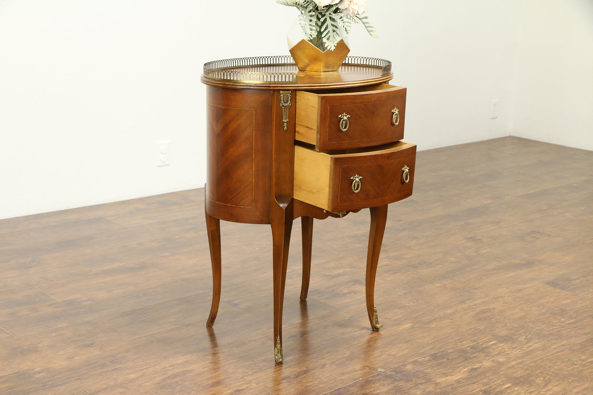 A pair of reproduction Louis XV style oval marquetry inlaid bedside chests,  width 47cm, depth 36cm